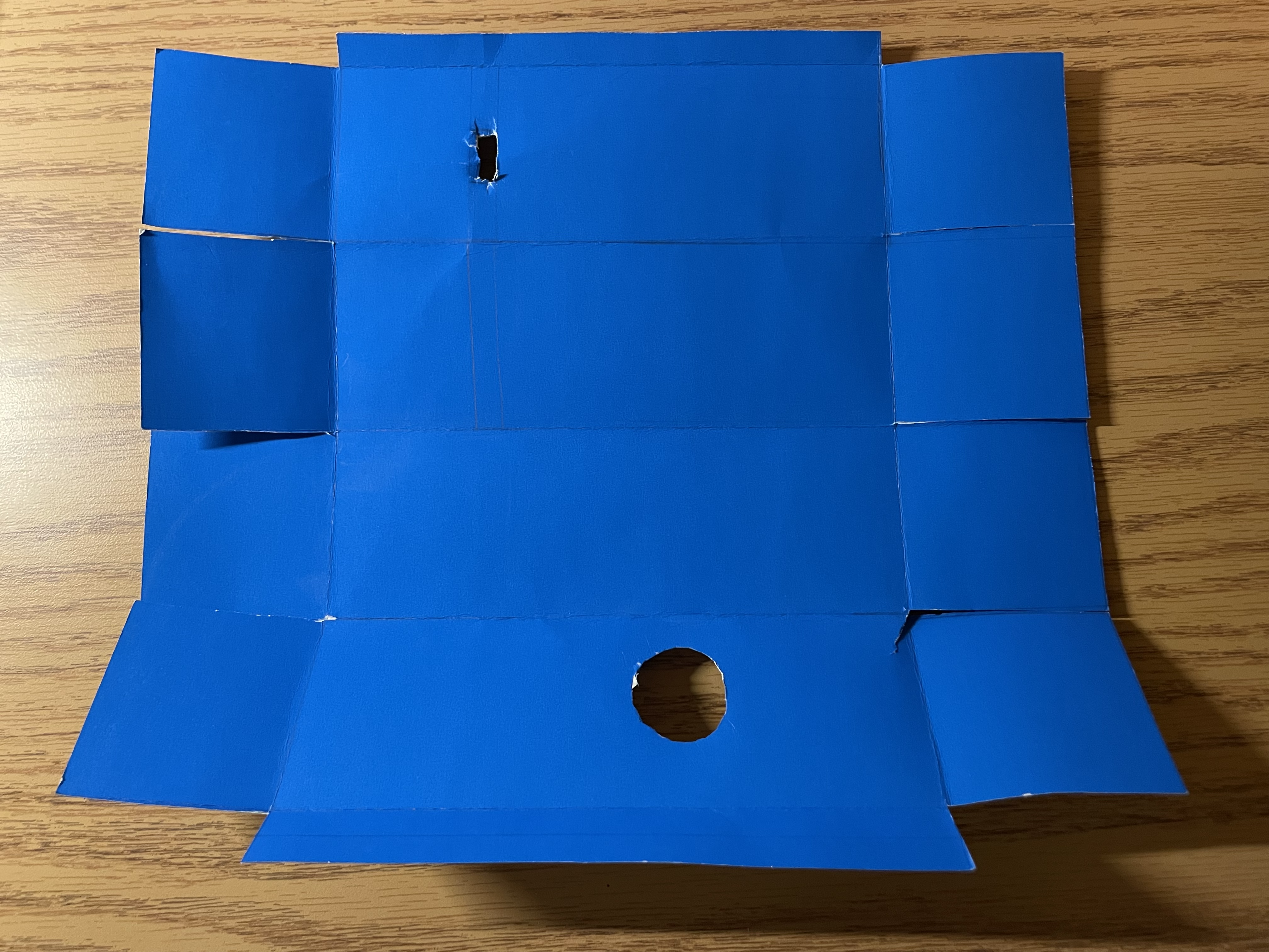 A blue cardboard cut to make a box.